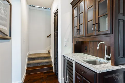 a bathroom with a granite countertop sink and washing machine