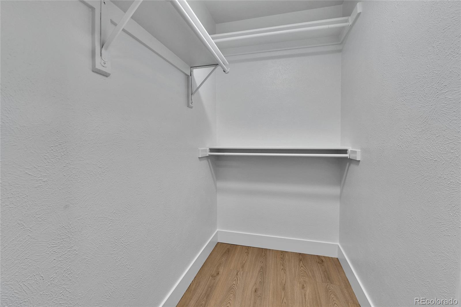 4878 East Kentucky Avenue, Unit E Denver, CO 80246 - Photo 12 of 19 a view of walk in closet with empty racks