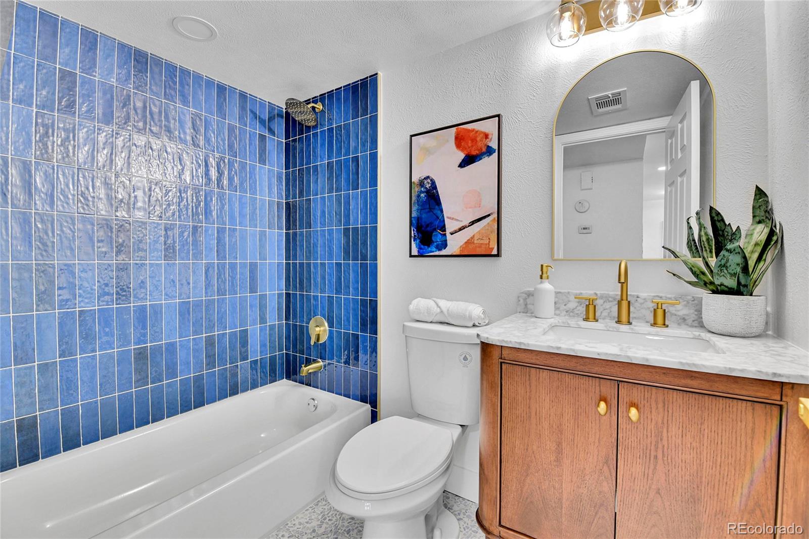 4878 East Kentucky Avenue, Unit E Denver, CO 80246 - Photo 14 of 19 a bathroom with a granite countertop sink mirror vanity and toilet