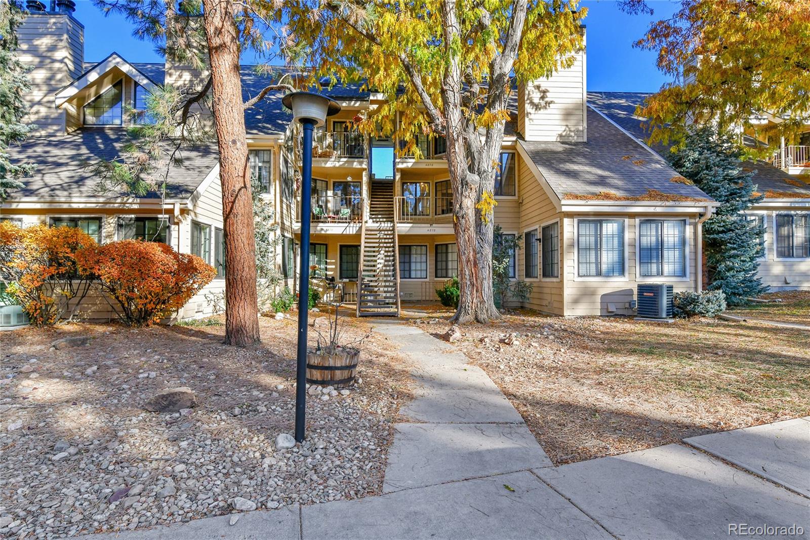 4878 East Kentucky Avenue, Unit E Denver, CO 80246 - Photo 18 of 19 a view of a brick house with many windows next to a road