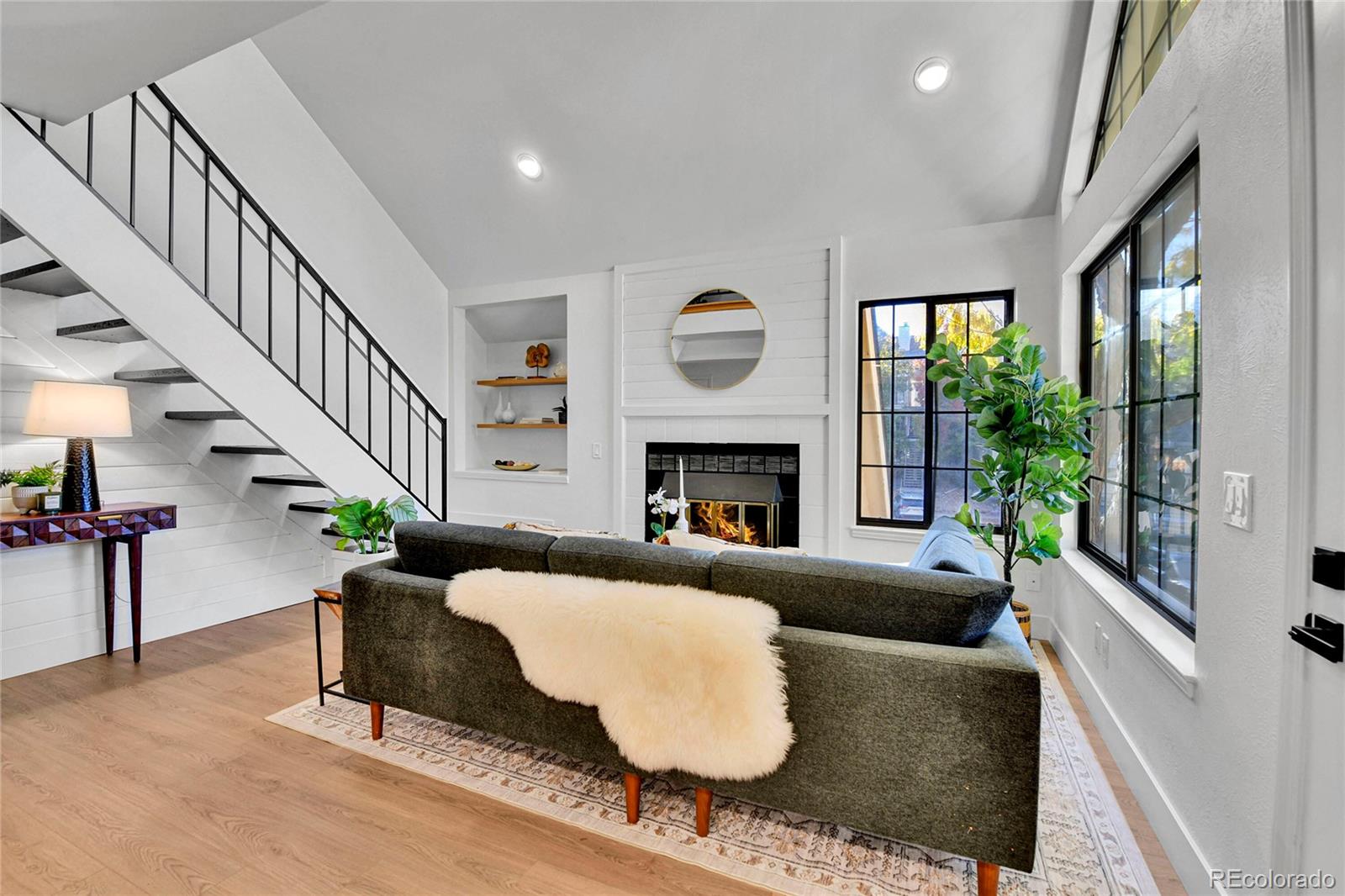 4878 East Kentucky Avenue, Unit E Denver, CO 80246 - Photo 2 of 19 a living room with furniture and a fireplace