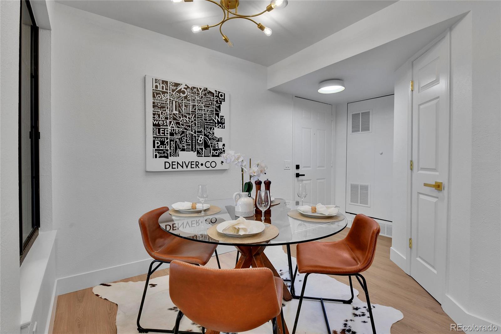4878 East Kentucky Avenue, Unit E Denver, CO 80246 - Photo 9 of 19 a view of a dining room with furniture and wooden floor