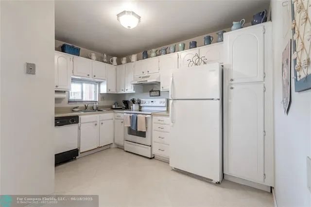 a living room with furniture a flat screen tv and a floor to ceiling window
