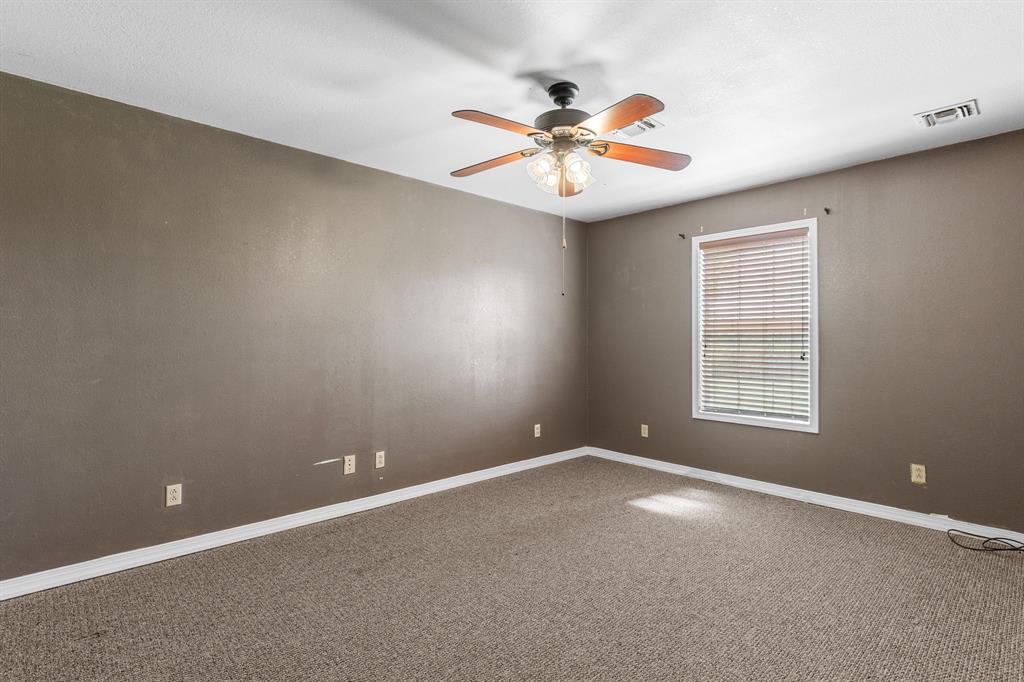 13315 Highway 281 Scotland, TX 76379 - Photo 26 of 40 Bedroom 4 featuring textured walls, neutral-toned carpet, and a ceiling fan with light kit
