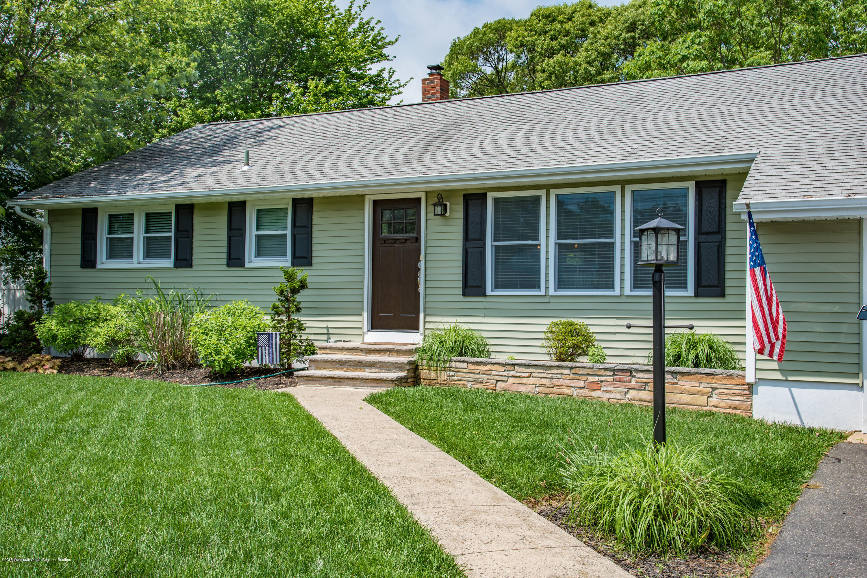 813 Beaver Dam Road Point Pleasant, NJ 08742 - Photo 27 of 27 a front view of a house with a yard table and chairs