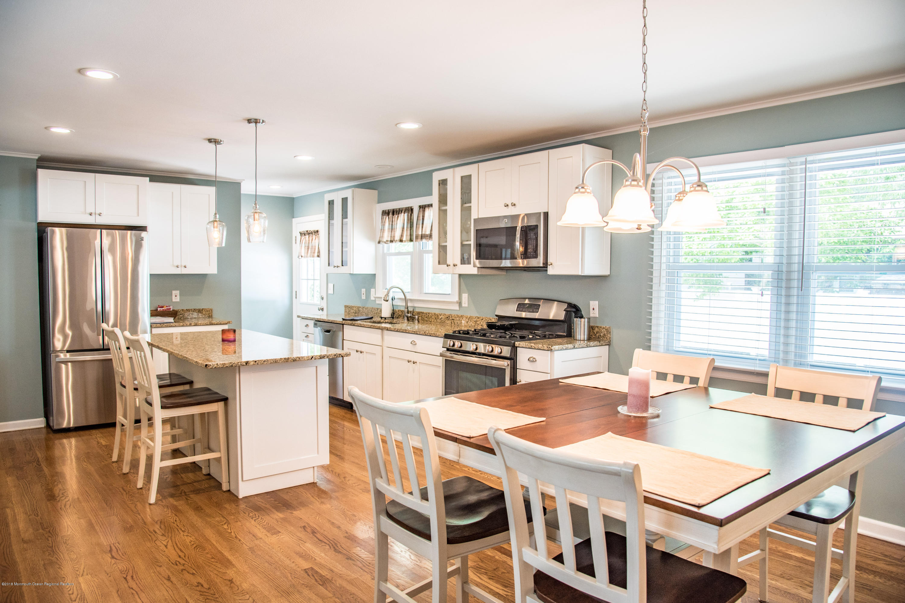 813 Beaver Dam Road Point Pleasant, NJ 08742 - Photo 8 of 27 a kitchen with stainless steel appliances granite countertop a stove top oven a refrigerator a sink and white cabinets with wooden floor