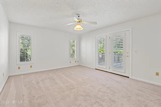 an empty room with windows and closet
