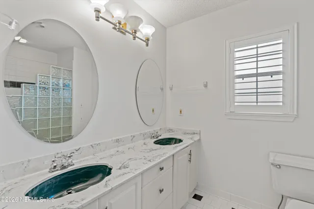 a bathroom with a granite countertop sink mirror and vanity