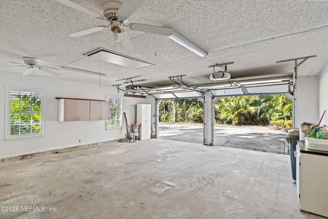 an aerial view of a residential houses with yard