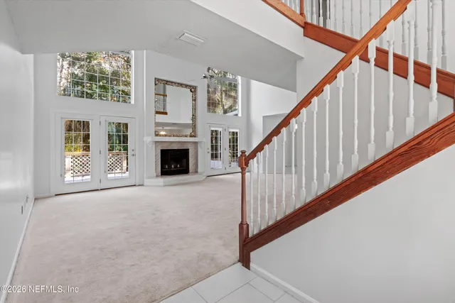a view of a livingroom with an entryway and fireplace