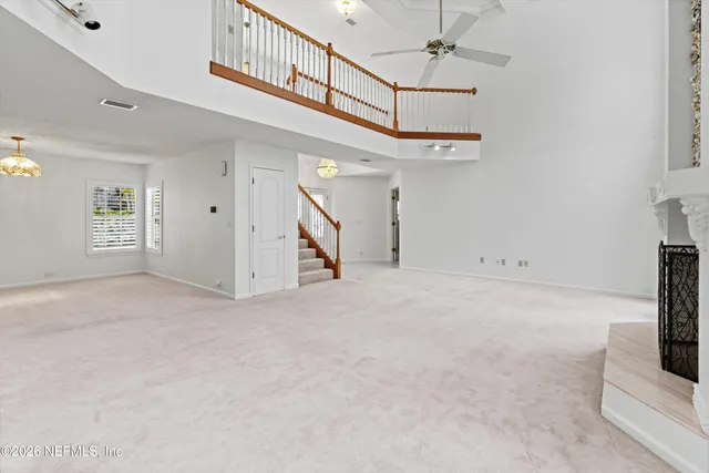 a view of a livingroom with a ceiling fan and window