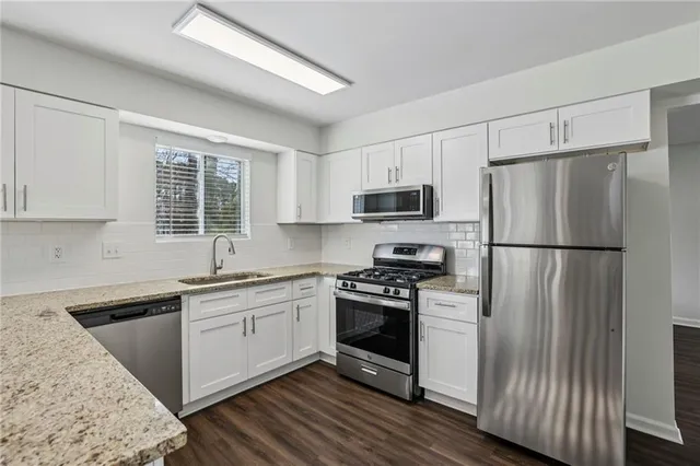 a kitchen with a refrigerator stove and sink