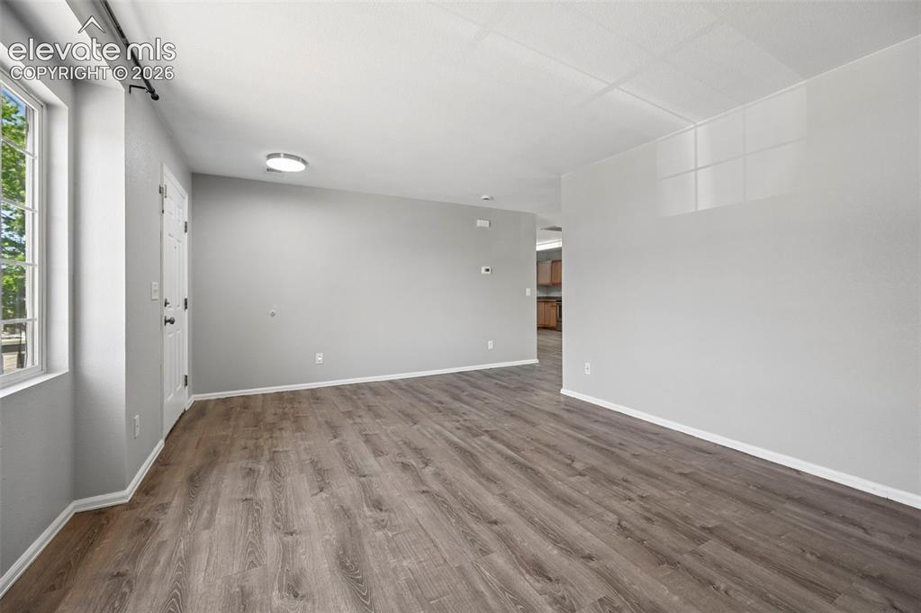 431 Kitfield View Colorado Springs, CO 80916 - Photo 10 of 27 wooden floor in an empty room with a window