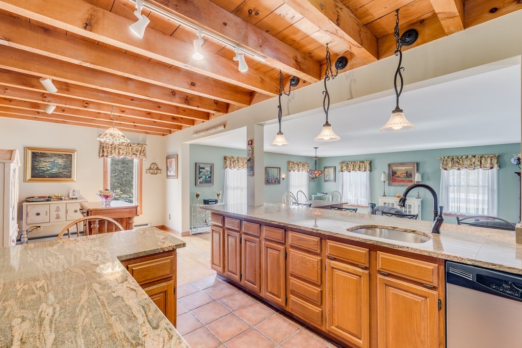 450 Main Street Rowley, MA 01969 - Photo 12 of 27 a large kitchen with stainless steel appliances granite countertop a sink and cabinets