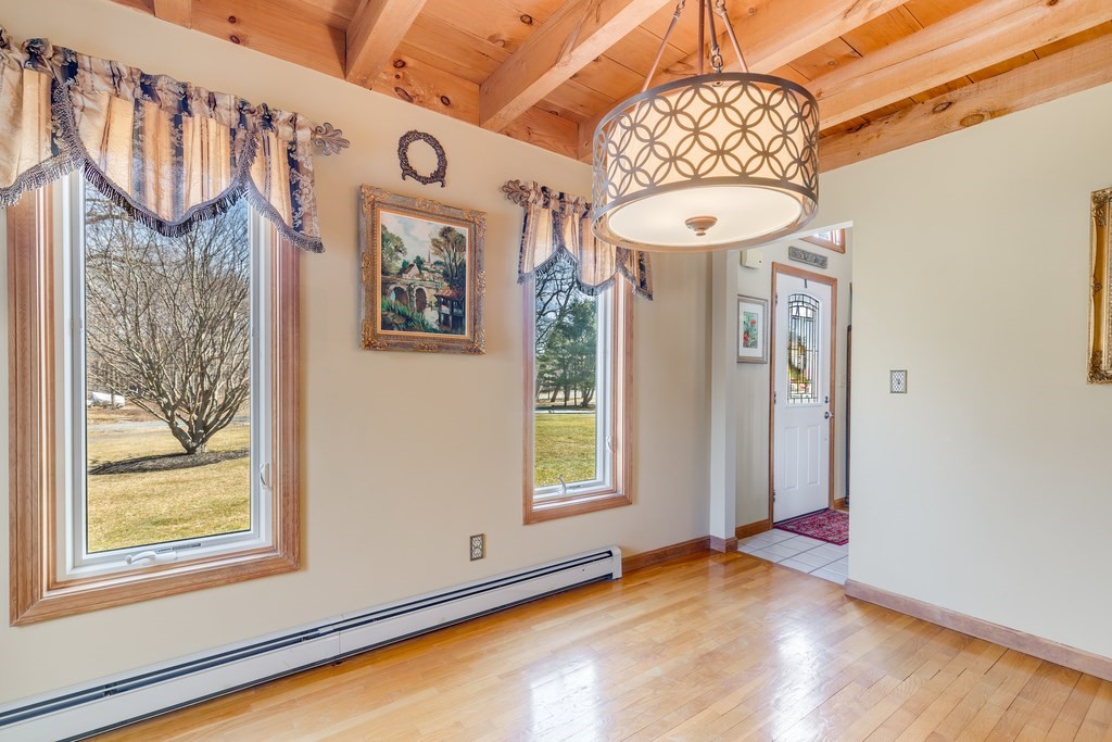 450 Main Street Rowley, MA 01969 - Photo 16 of 27 a view of a hallway with windows and chandelier