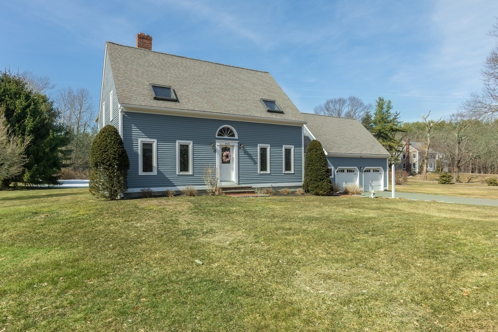 450 Main Street Rowley, MA 01969 - Photo 2 of 27 a front view of a house with a garden