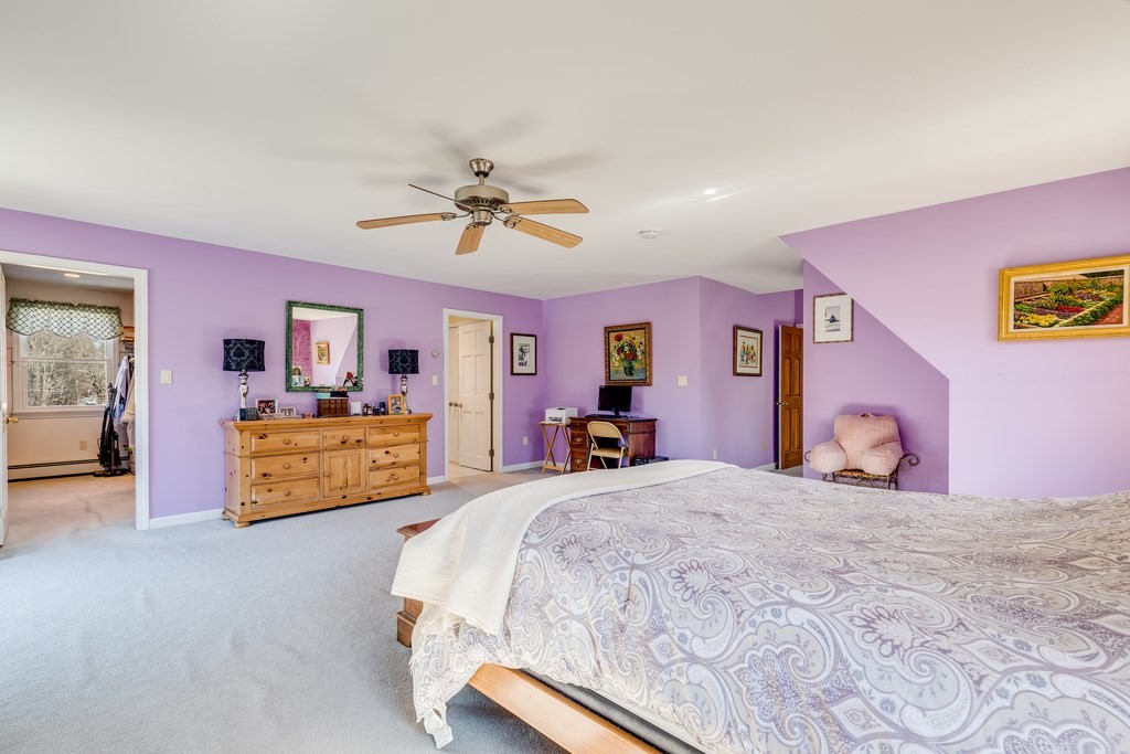 450 Main Street Rowley, MA 01969 - Photo 22 of 27 a bedroom with a large bed and a chandelier
