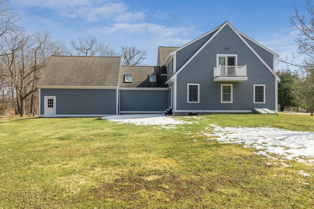 450 Main Street Rowley, MA 01969 - Photo 3 of 27 a front view of house with yard and trees in the background