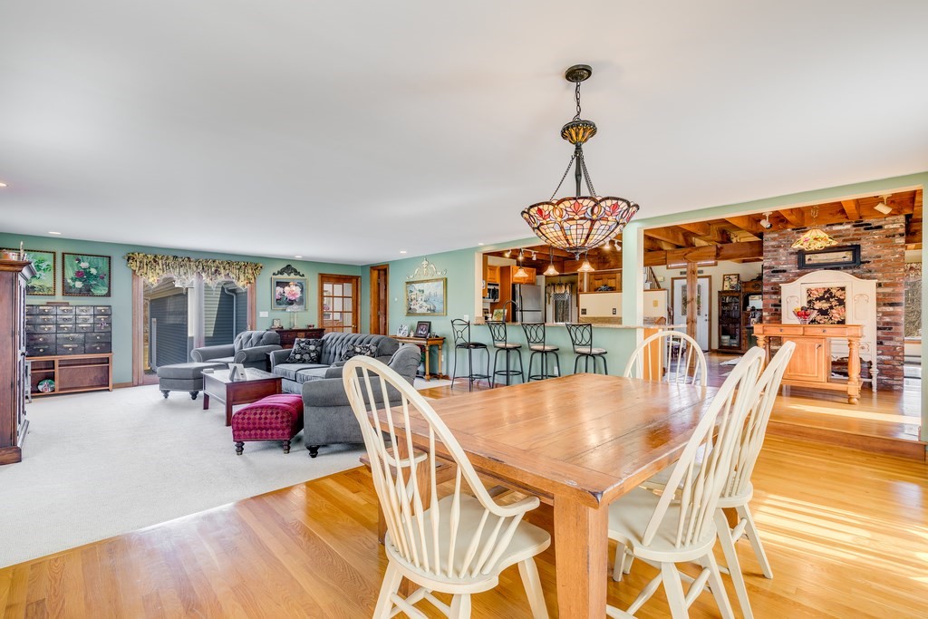 450 Main Street Rowley, MA 01969 - Photo 6 of 27 a dining room with furniture a chandelier and wooden floor