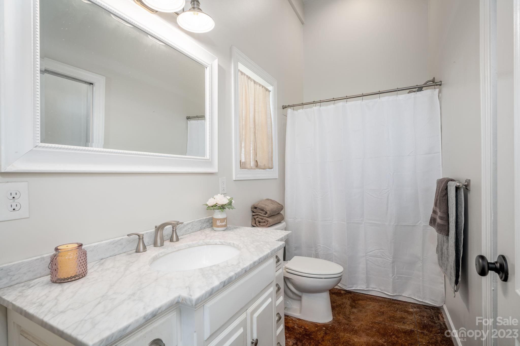 340 Foster Road Cleveland, NC 27013 - Photo 11 of 44 a bathroom with a granite countertop sink toilet and shower