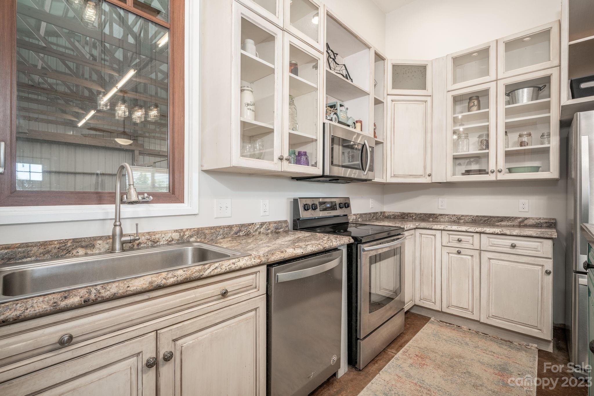 340 Foster Road Cleveland, NC 27013 - Photo 16 of 44 a kitchen with stainless steel appliances granite countertop a sink and a stove