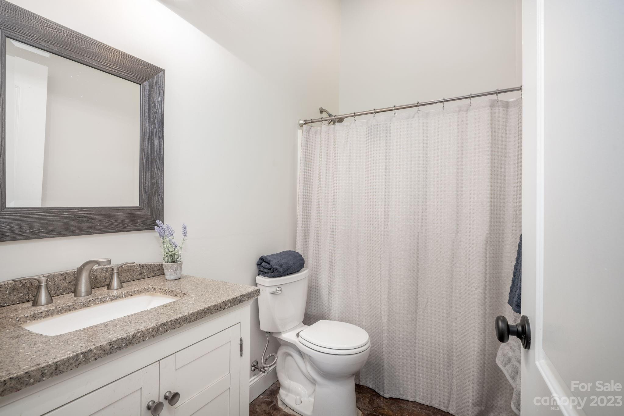 340 Foster Road Cleveland, NC 27013 - Photo 20 of 44 a bathroom with a granite countertop sink and a mirror