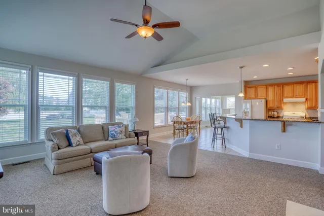 a dining room with furniture a chandelier and wooden floor