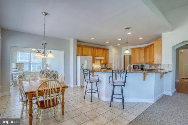 a kitchen with granite countertop a sink and cabinets