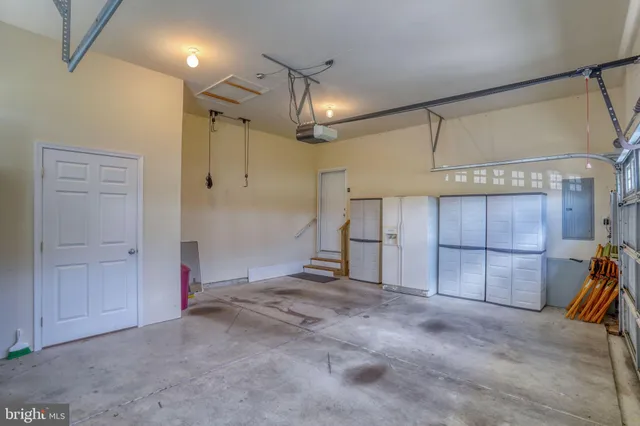 a man walking down a street next to a building