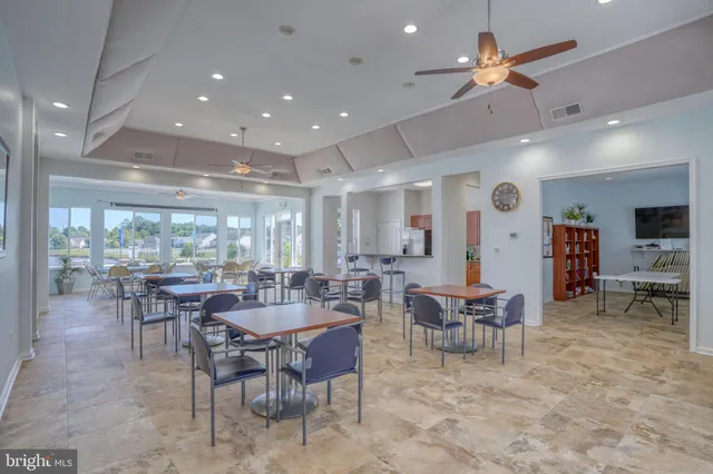 a view of group of people sitting in front of retail shops