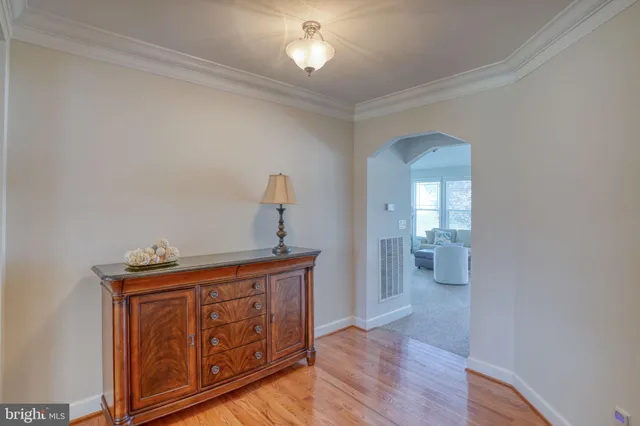 a dining room with furniture a chandelier and wooden floor