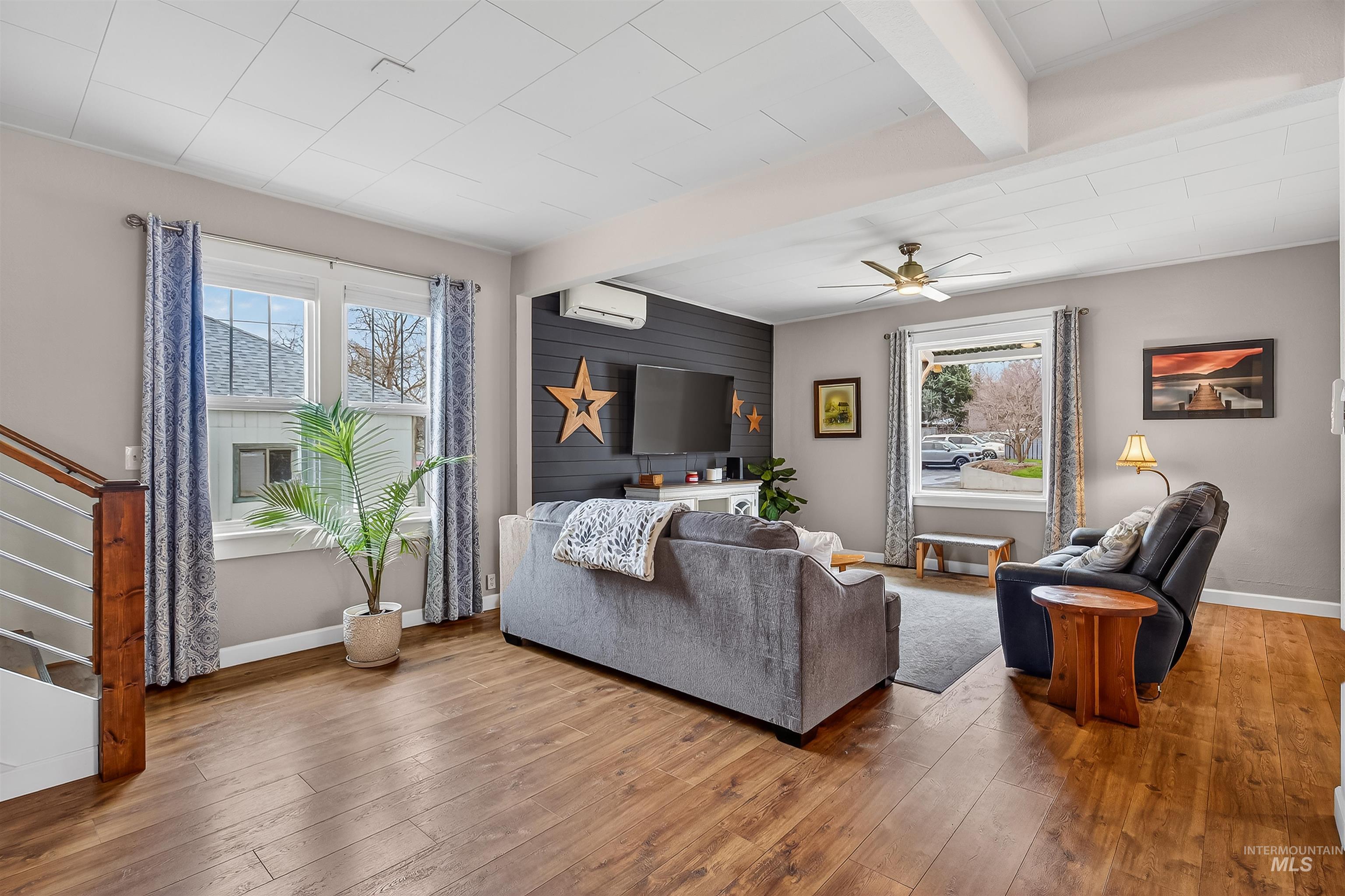 716 Chestnut Street Clarkston, WA 99403 - Photo 11 of 49 Living room with beam ceiling, ceiling fan, hardwood / wood-style flooring, and healthy amount of natural light