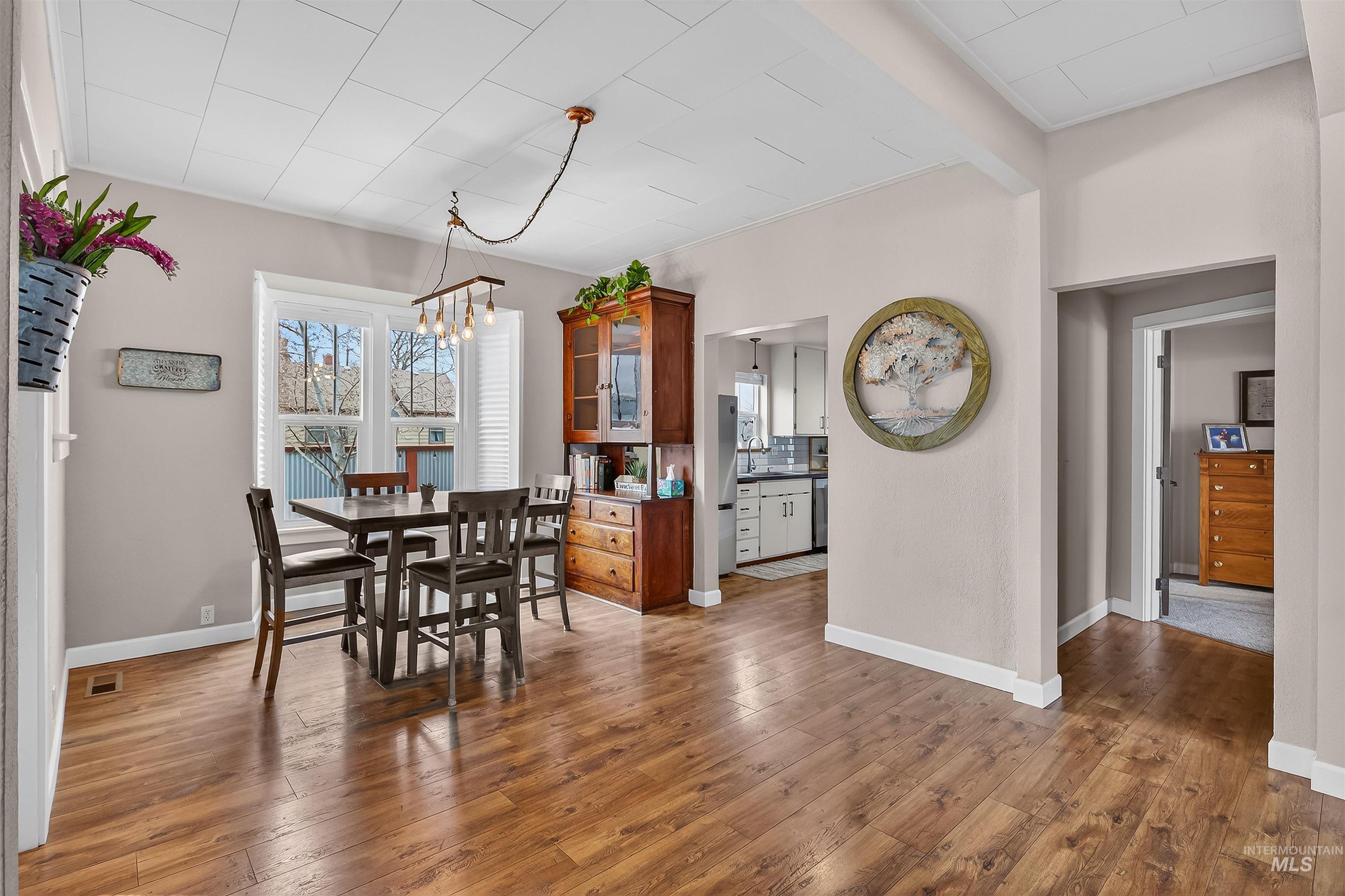 716 Chestnut Street Clarkston, WA 99403 - Photo 12 of 49 Dining area with light wood-type flooring, hanging lights, and beam ceiling