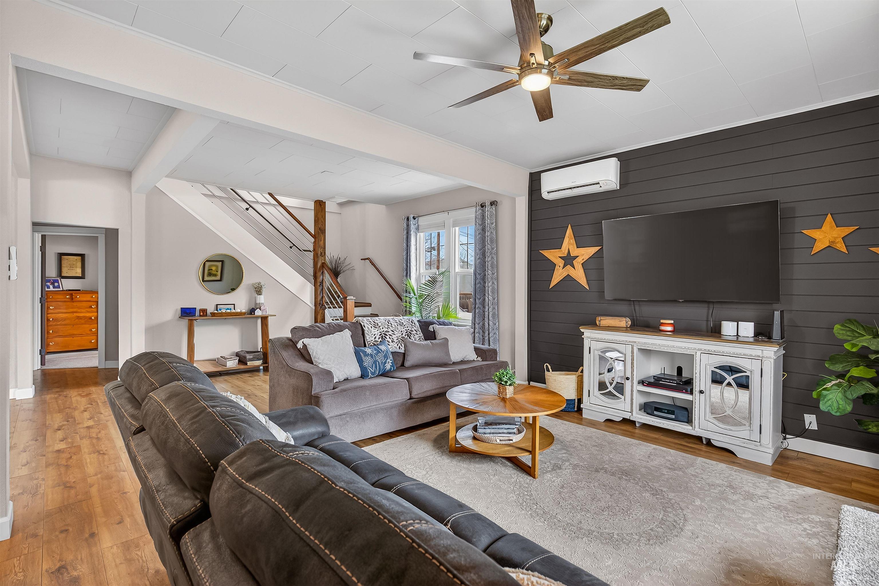 716 Chestnut Street Clarkston, WA 99403 - Photo 14 of 49 Living room featuring light wood-type flooring, ceiling fan, and wooden walls