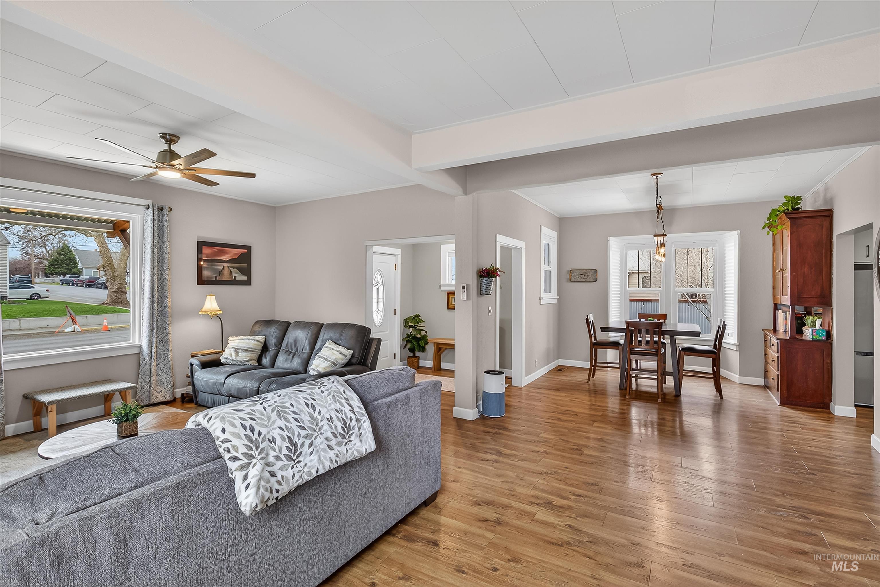 716 Chestnut Street Clarkston, WA 99403 - Photo 18 of 49 Living room with light wood-type flooring, a ceiling fan, plenty of natural light, and beamed ceiling