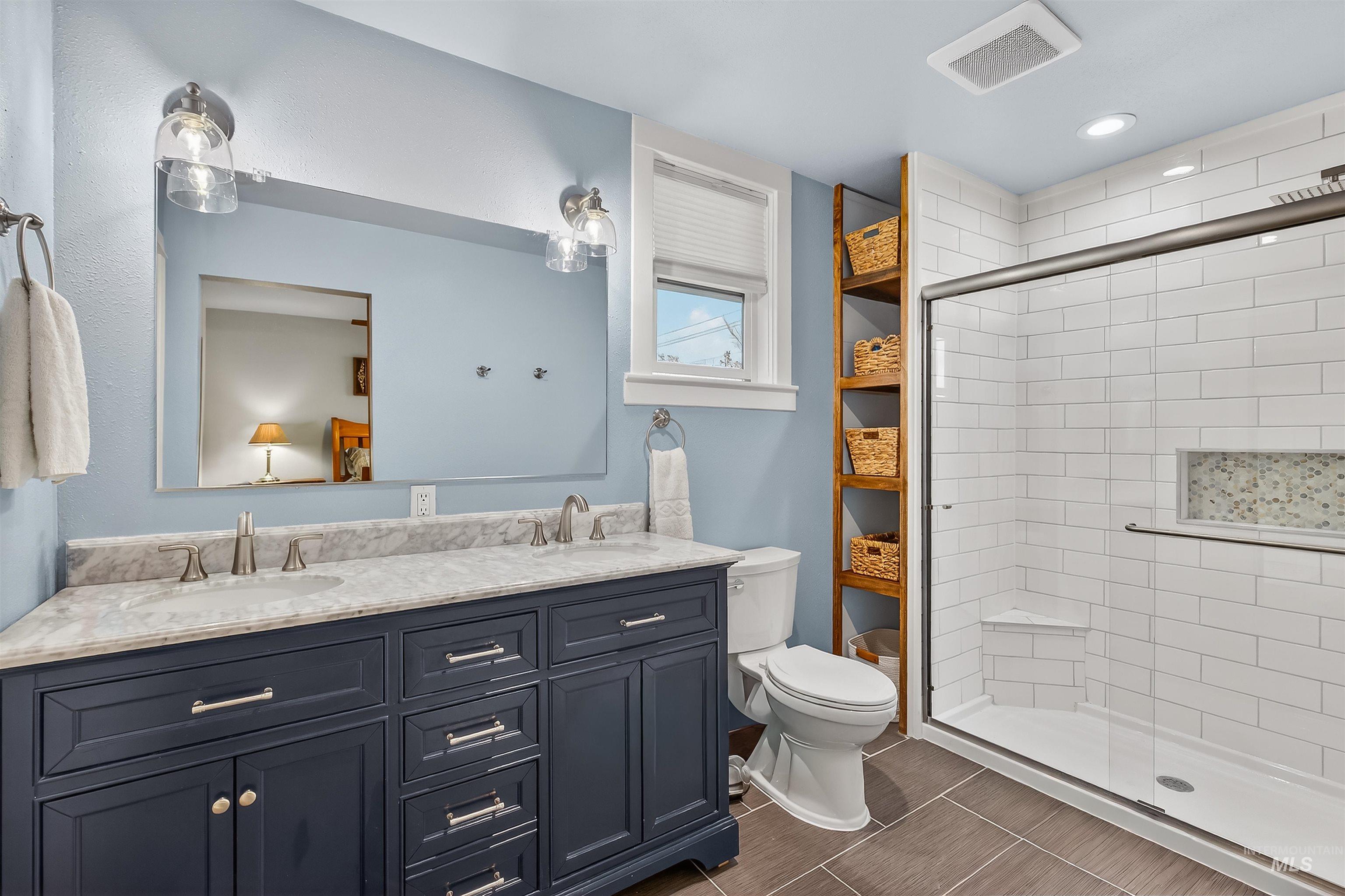 716 Chestnut Street Clarkston, WA 99403 - Photo 24 of 49 Full bath with double vanity, a stall shower, and recessed lighting