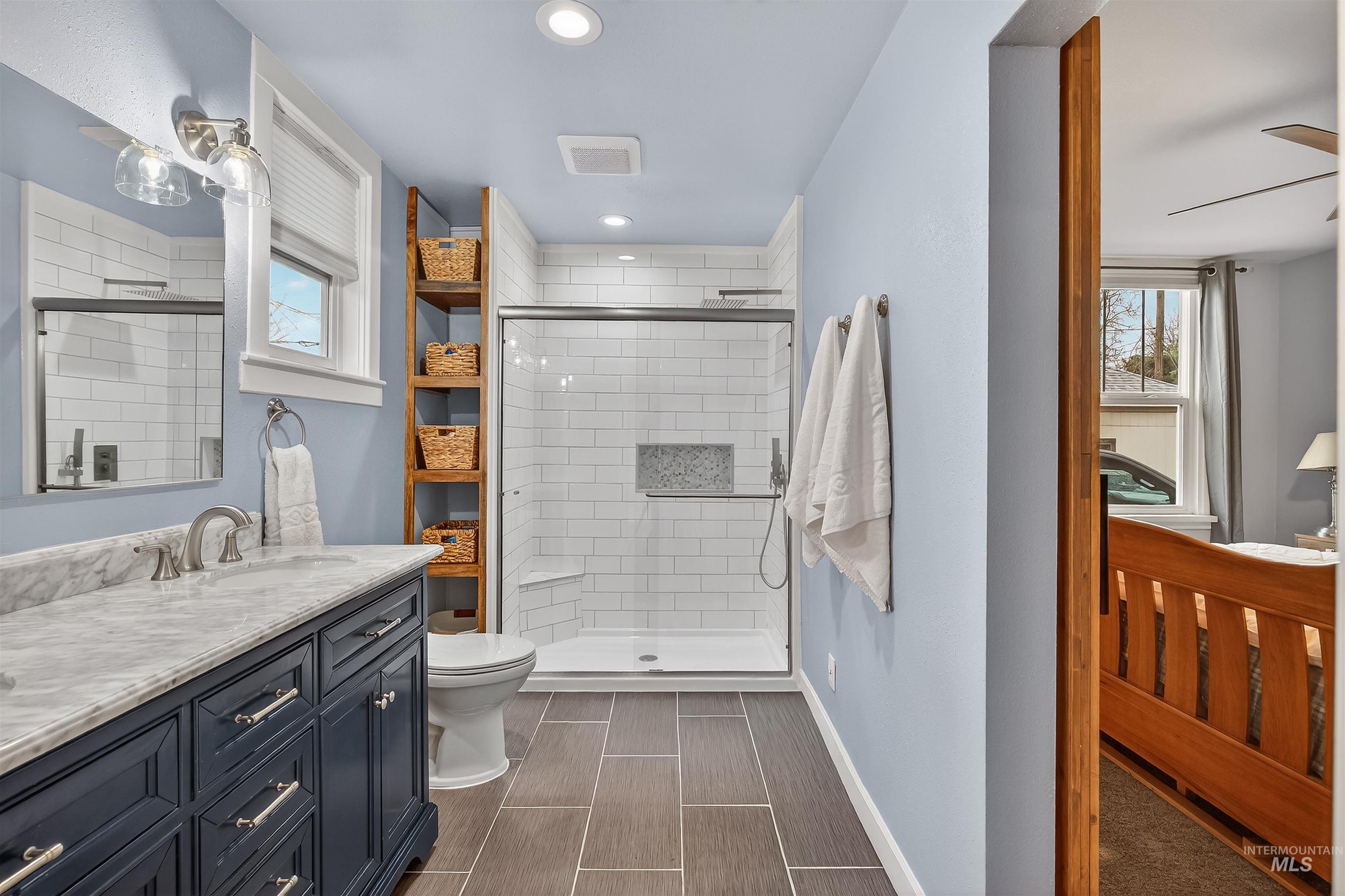 716 Chestnut Street Clarkston, WA 99403 - Photo 26 of 49 Bathroom featuring double vanity, a shower stall, recessed lighting, and a ceiling fan