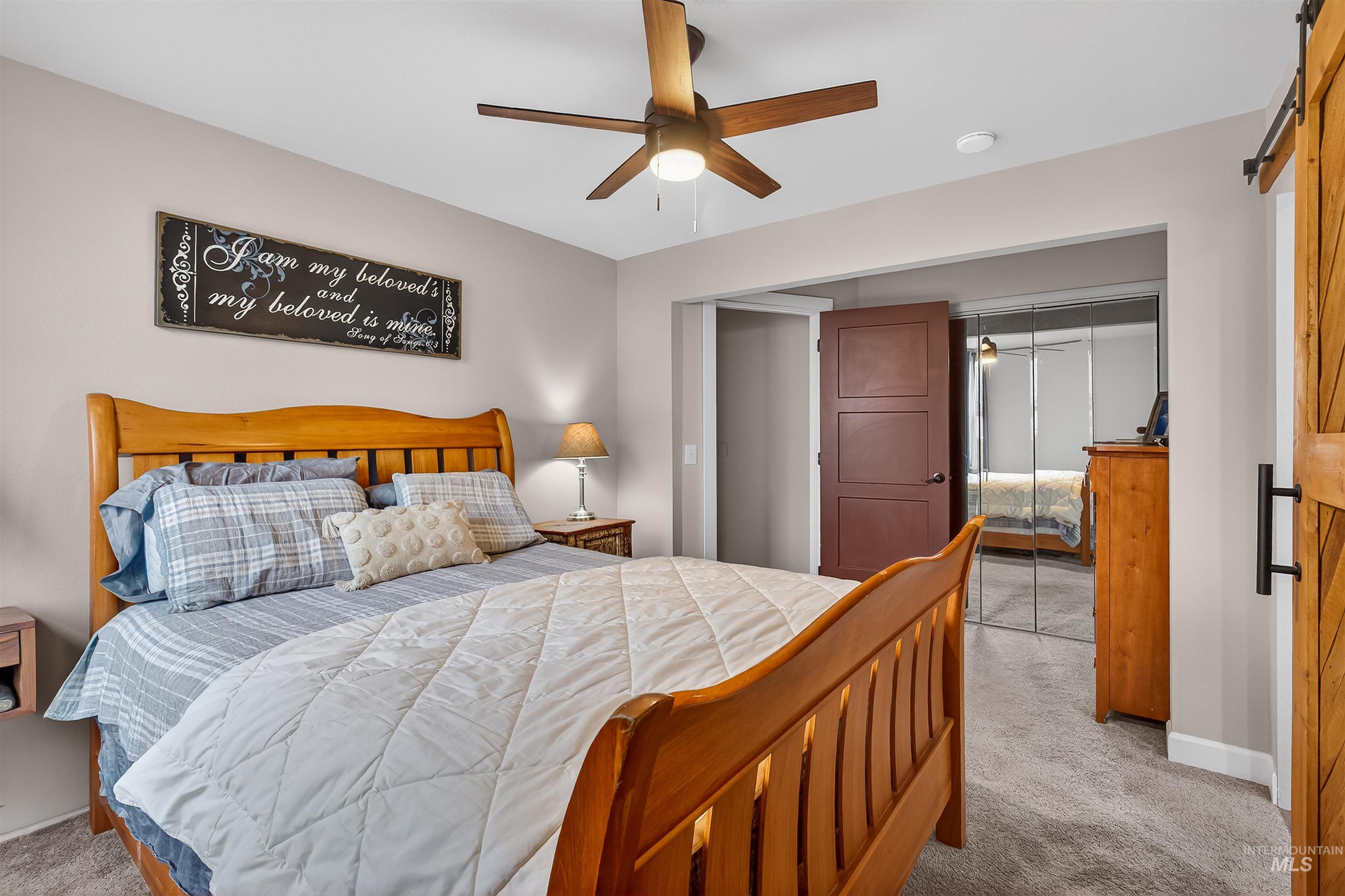 716 Chestnut Street Clarkston, WA 99403 - Photo 30 of 49 Bedroom with a closet, light carpet, a barn door, and ceiling fan