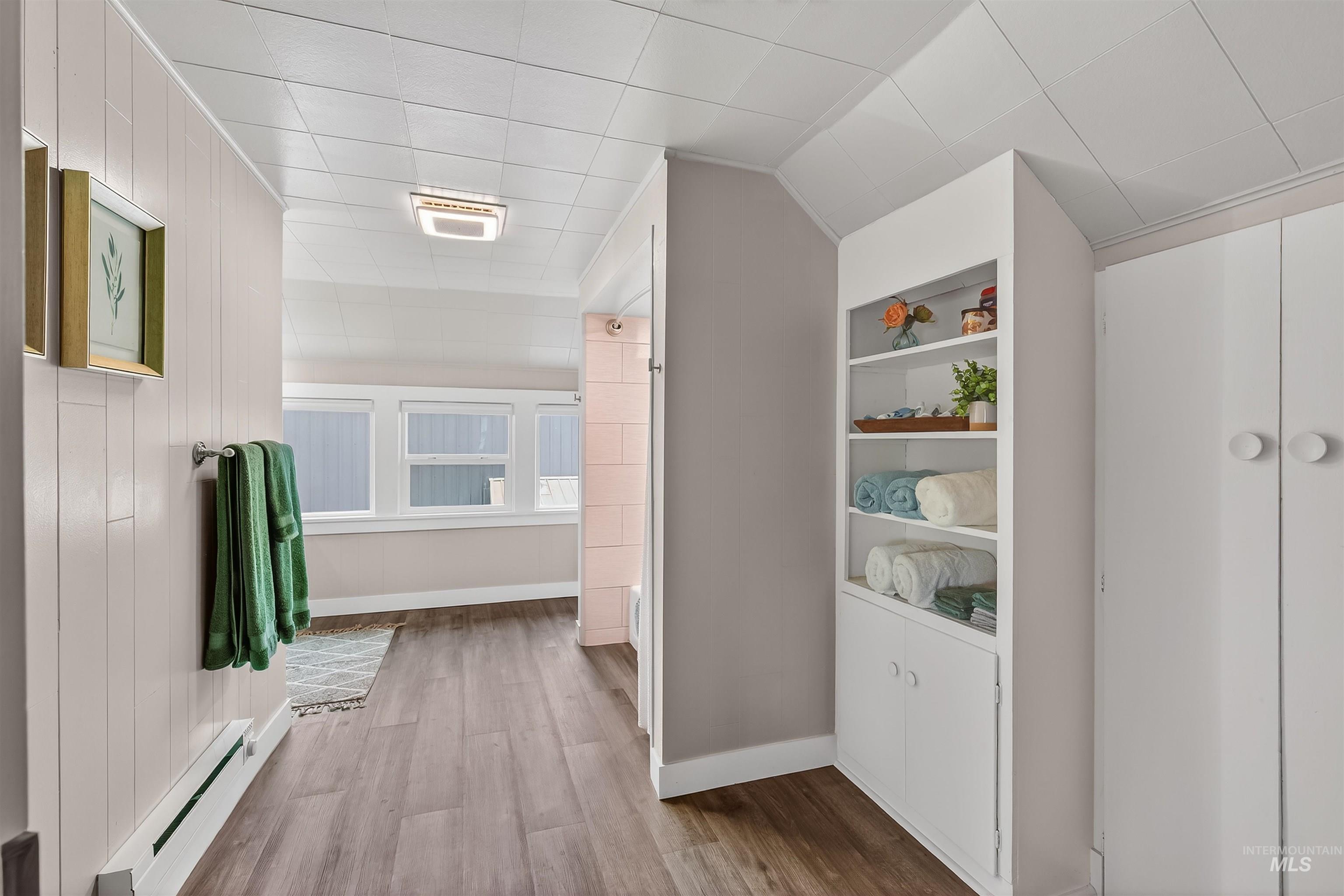 716 Chestnut Street Clarkston, WA 99403 - Photo 33 of 49 Hall featuring a baseboard radiator, light wood-style flooring, and built in shelves