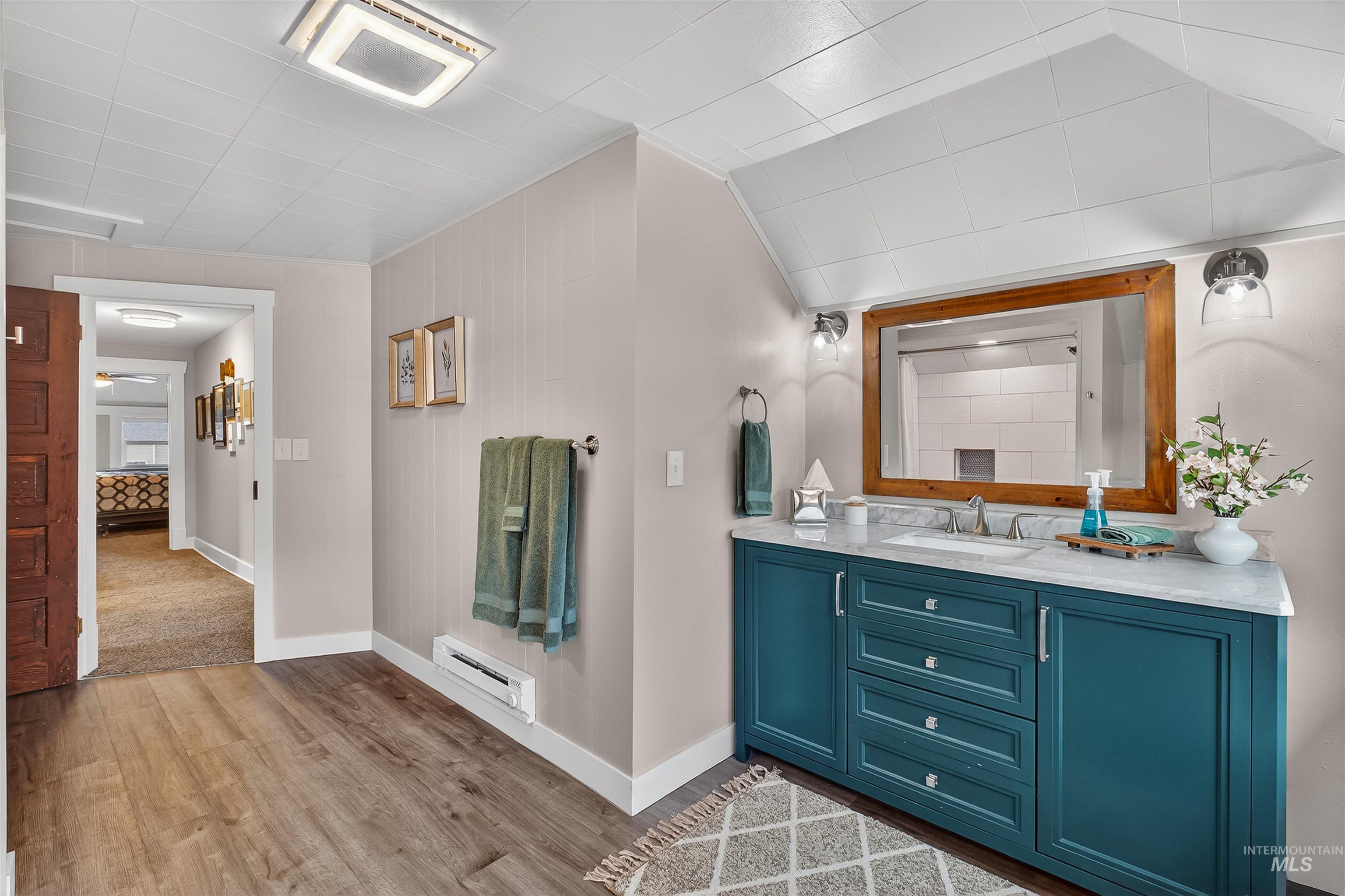 716 Chestnut Street Clarkston, WA 99403 - Photo 37 of 49 Full bathroom with vanity, light wood-type flooring, and a baseboard heating unit