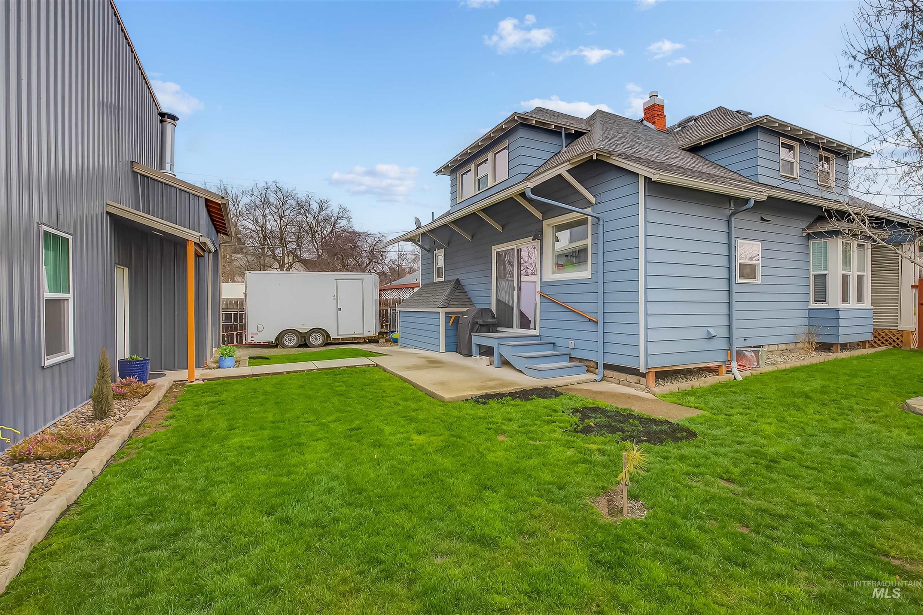 716 Chestnut Street Clarkston, WA 99403 - Photo 48 of 49 View of front of house featuring a front lawn, a chimney, roof with shingles, and a shed