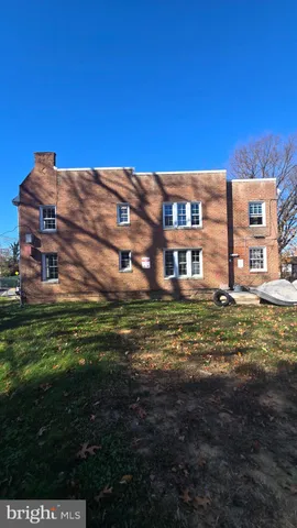 a front view of a residential apartment building with a yard