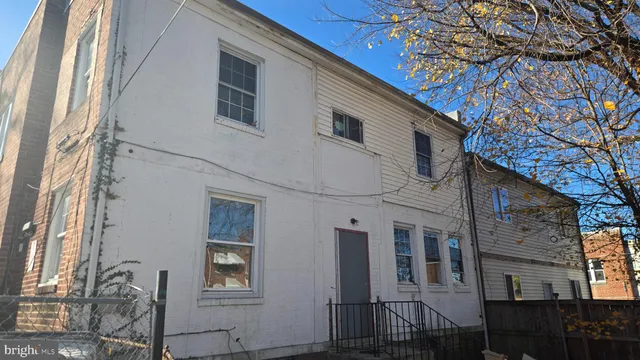 a front view of a house with a tree