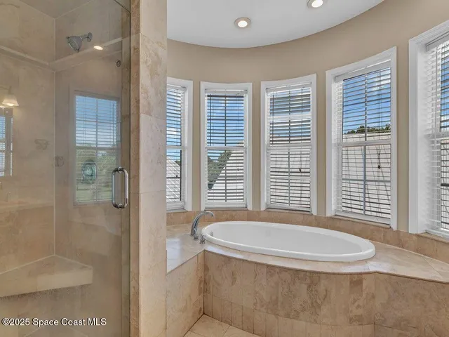 a bathroom with a tub and a shower