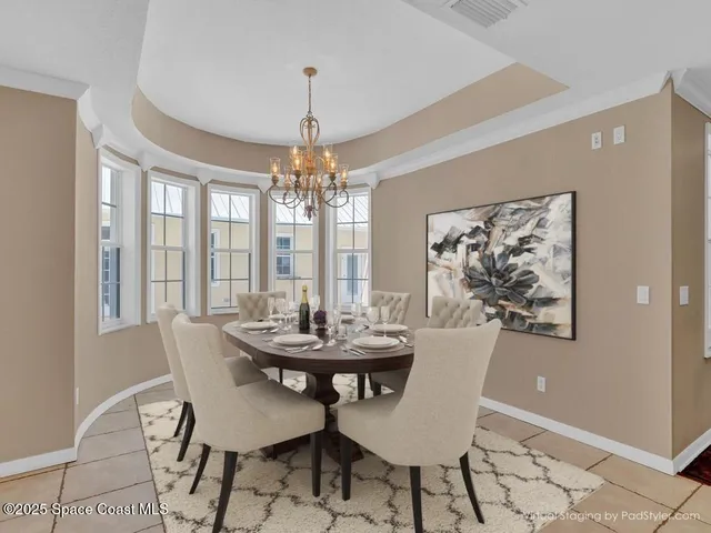 a view of a dining room with furniture and chandelier