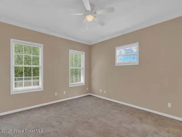 an empty room with windows and closet