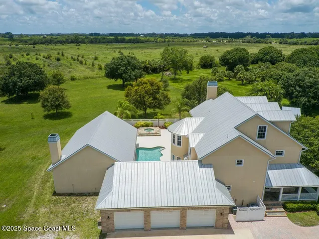 an aerial view of a house with a yard