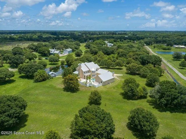 a view of a garden with a building in the background