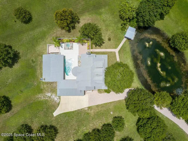 an aerial view of a house with a yard