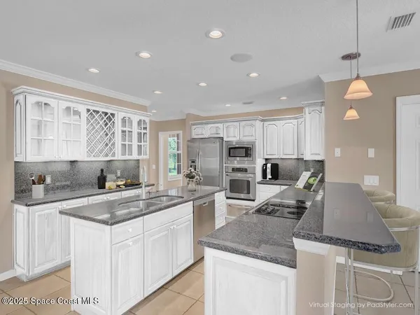 a kitchen with a sink stove and refrigerator